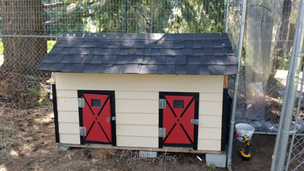 Picture of a dog house converted into a functioning chicken coop.