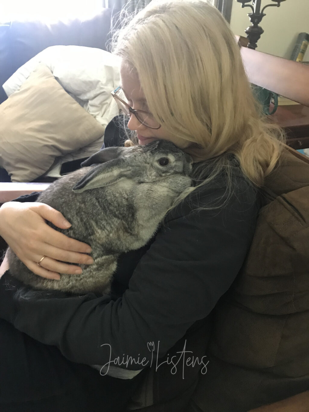 Cuddling with my rabbit Houdini while sitting in a rocking chair.