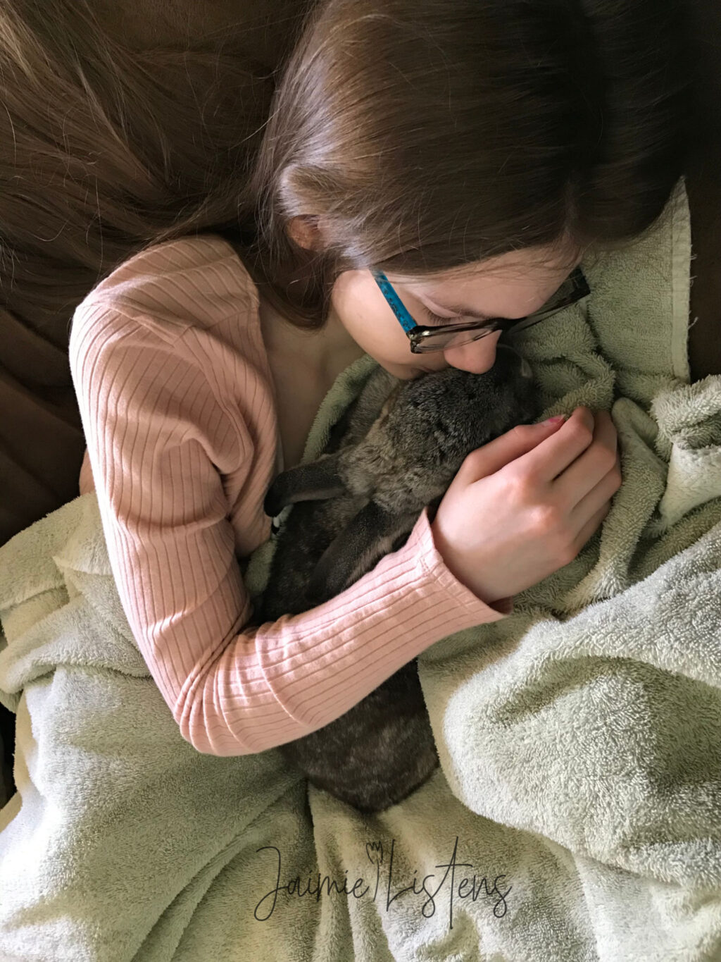 Rabbit cuddling with her big sis.