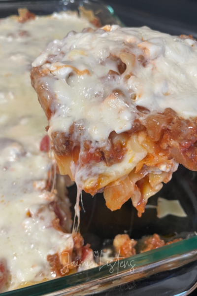Easy homemade lasagna with cottage cheese being dished out.