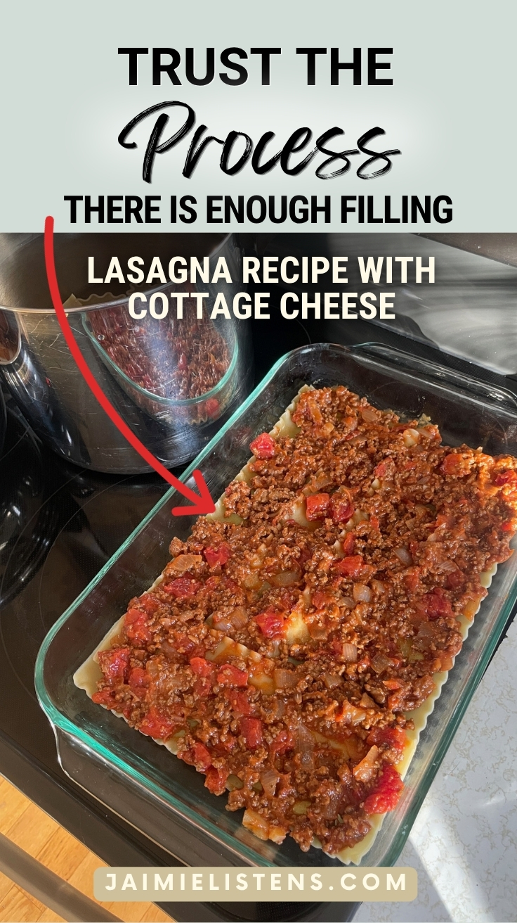 Thin layer of hamburger filling spread across lasagna noodles during homemade lasagna recipe assembly.
