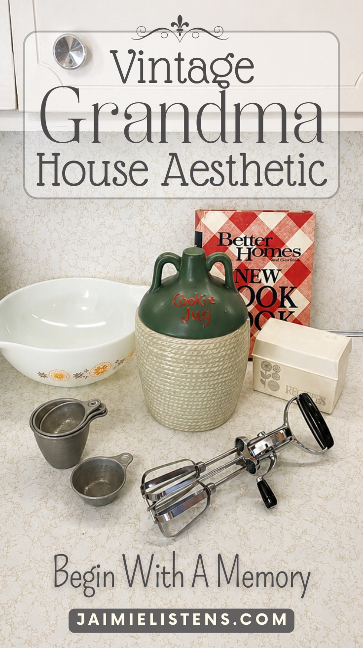 Vintage kitchen display featuring a cookie jug, recipe box, Better Homes and Gardens cookbook, Pyrex bowl, measuring cups, and vintage hand mixer on a retro countertop. Pin text reads: Begin With A Memory.